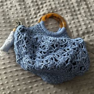 The Sak crochet blue bucket bag